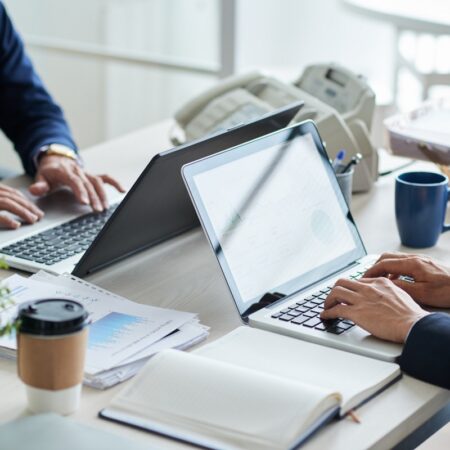 side-view-cropped-unrecognizable-business-people-working-common-desk side-view-cropped-unrecognizable-business-people-working-common-desk